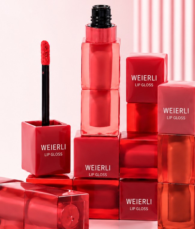 Private label lip gloss products on a pink studio set